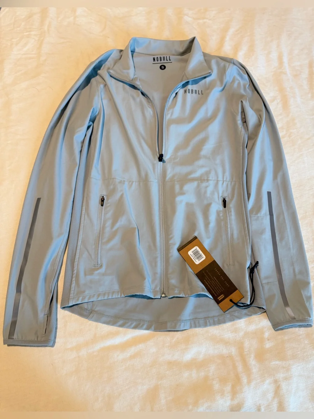 NOBULL Women’s Performance Jacket with Reflective Trim in Quart (silver/gray) - Picture 1 of 5